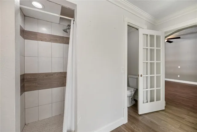 a bedroom with a bed and ceiling fan