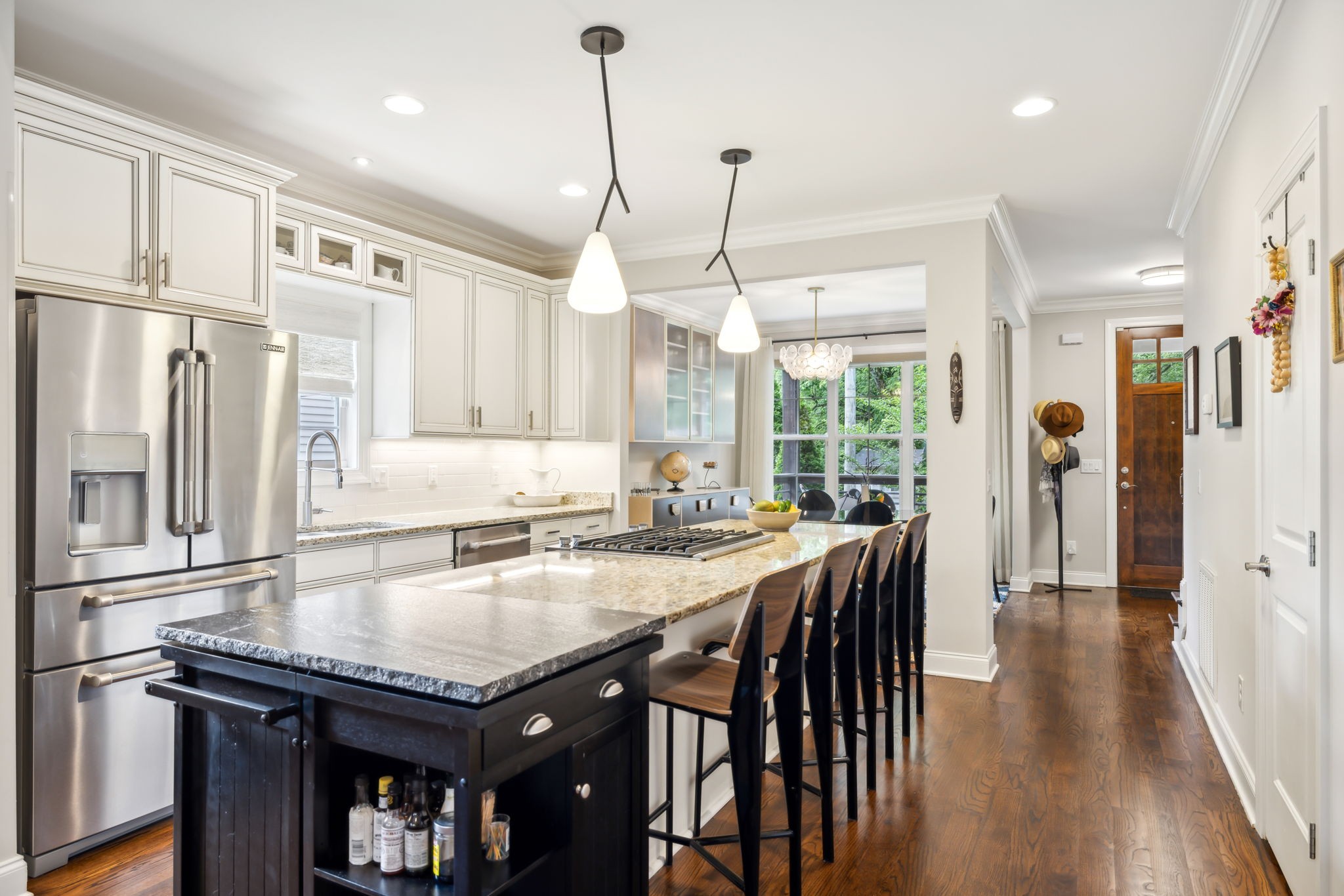 948 Glass Street Franklin, TN 37064 - Photo 9 of 40 a kitchen with stainless steel appliances granite countertop a stove a refrigerator a sink a dining table and chairs with wooden floor