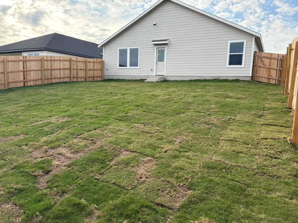 a view of a house with a backyard