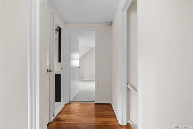 a view of hallway with wooden floor