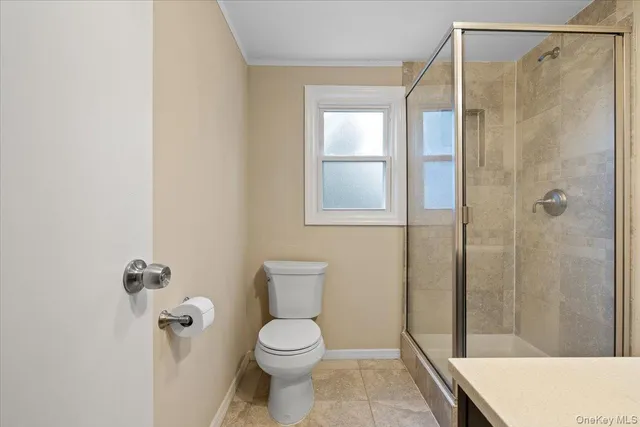 a bathroom with a shower a toilet and a sink