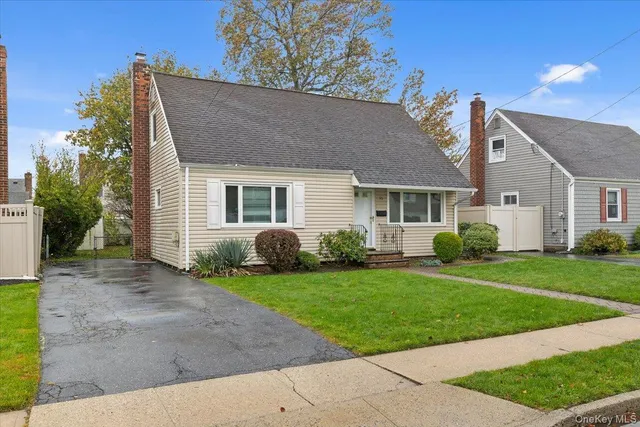 a house that has a big yard plants and large trees