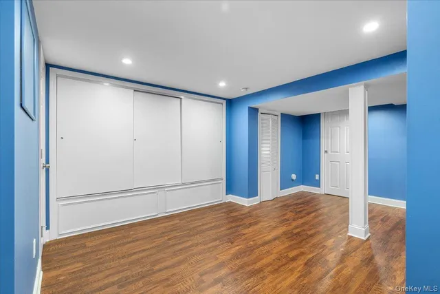 a view of a backyard with plants and large tree