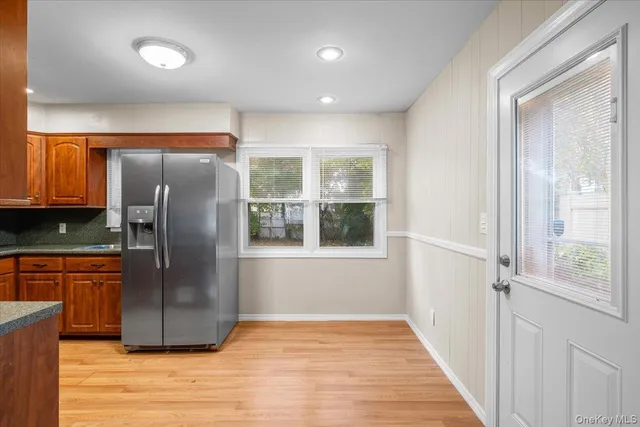 a kitchen with stainless steel appliances granite countertop a refrigerator and a sink