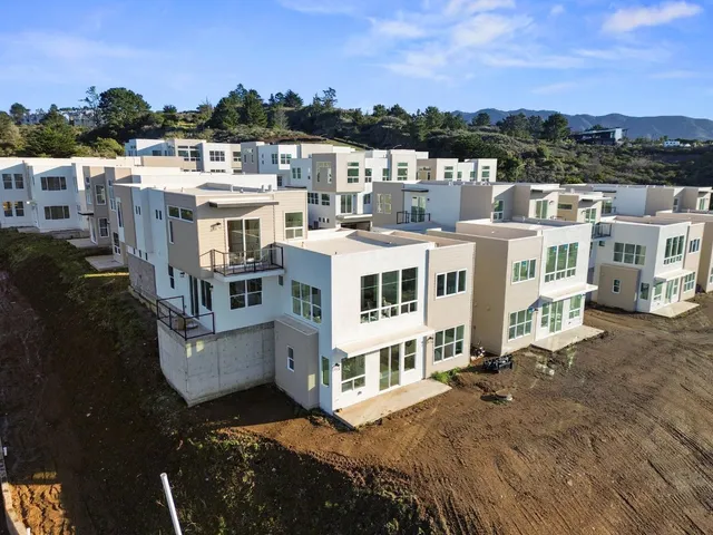 a large white building with a view of buildings