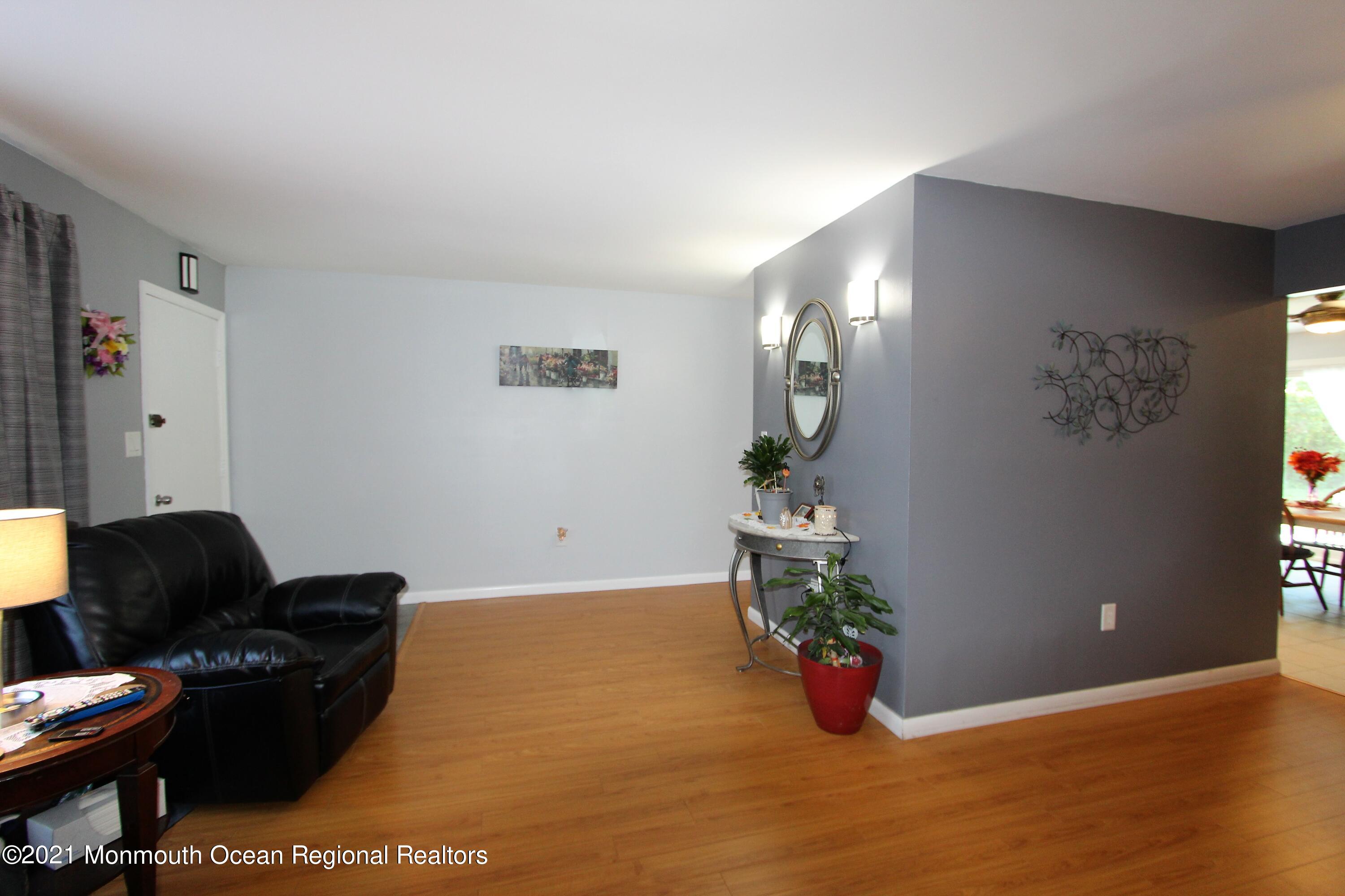 18 Rothbard Road Hazlet, NJ 07730 - Photo 13 of 23 a living room with furniture and flowers
