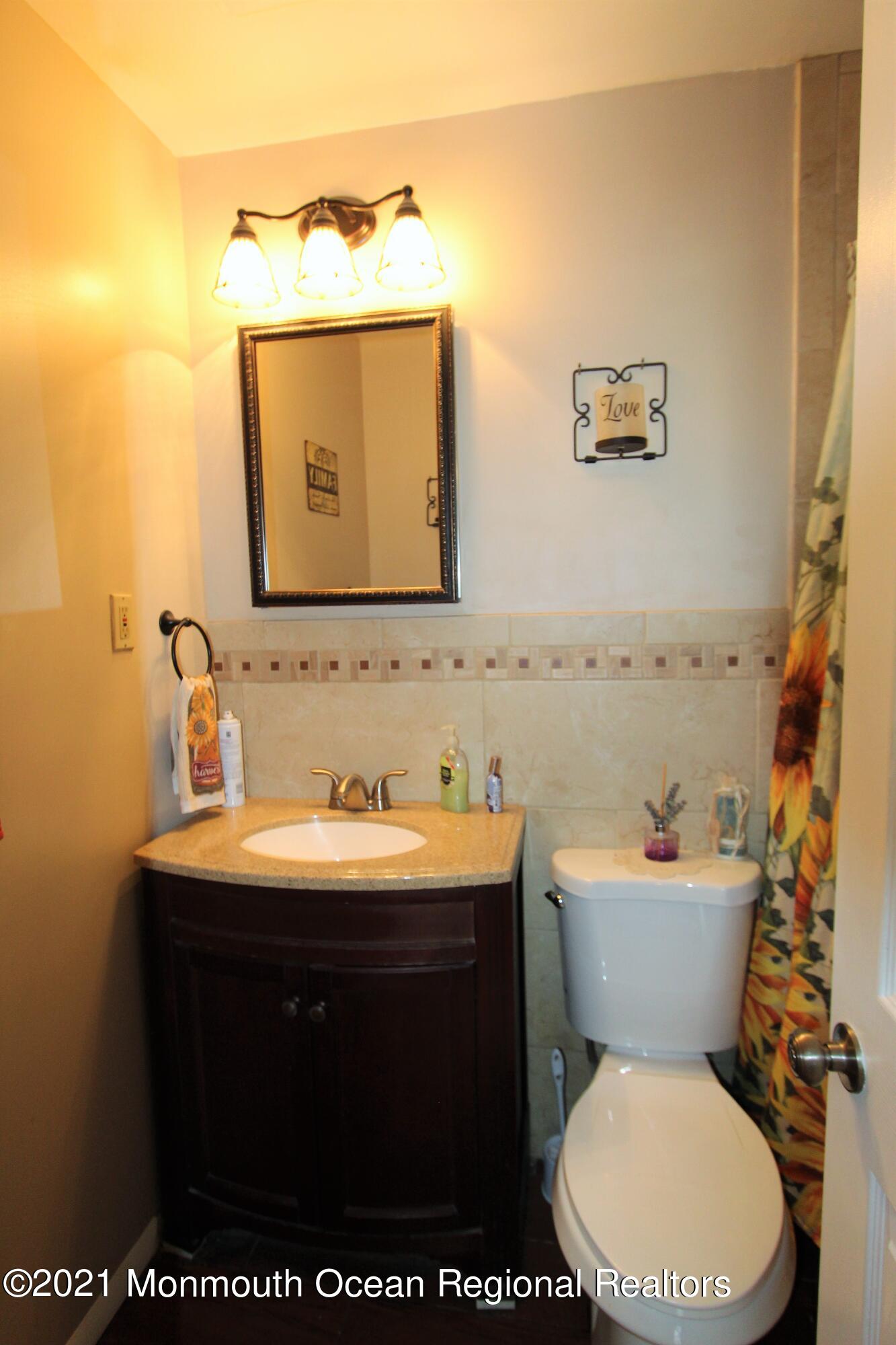 18 Rothbard Road Hazlet, NJ 07730 - Photo 18 of 23 a bathroom with a toilet sink and mirror
