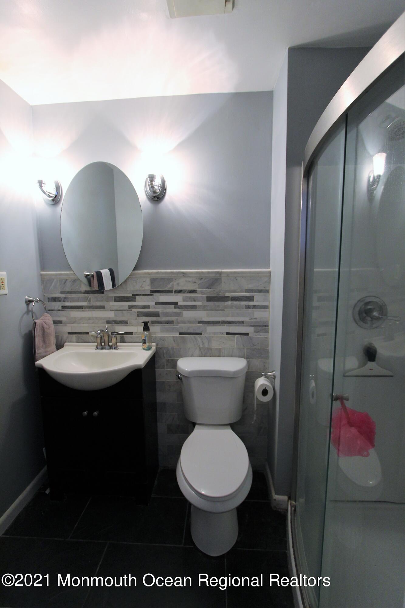 18 Rothbard Road Hazlet, NJ 07730 - Photo 21 of 23 a bathroom with a toilet a sink and mirror