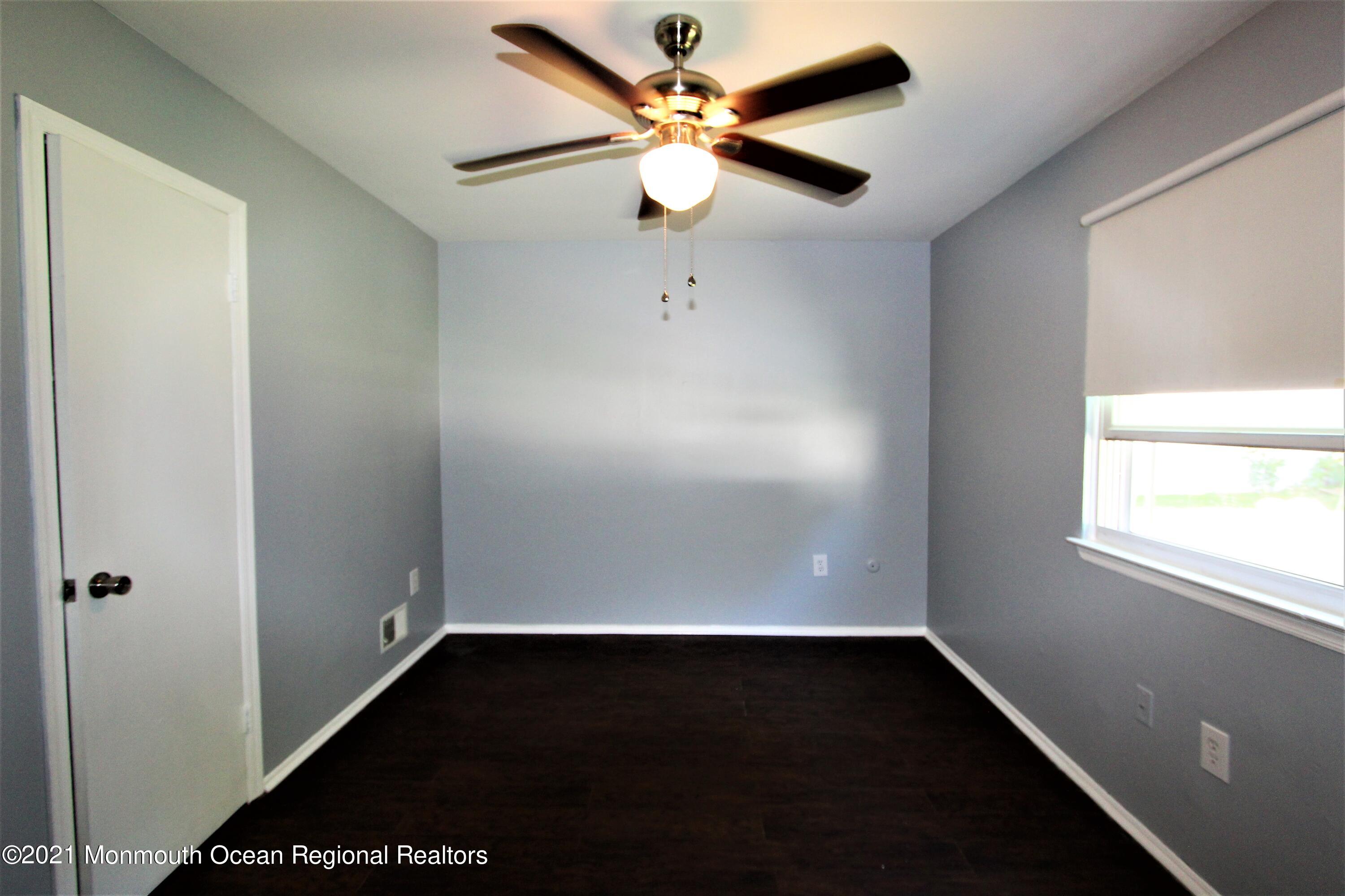 18 Rothbard Road Hazlet, NJ 07730 - Photo 22 of 23 an empty room with a window and a ceiling fan