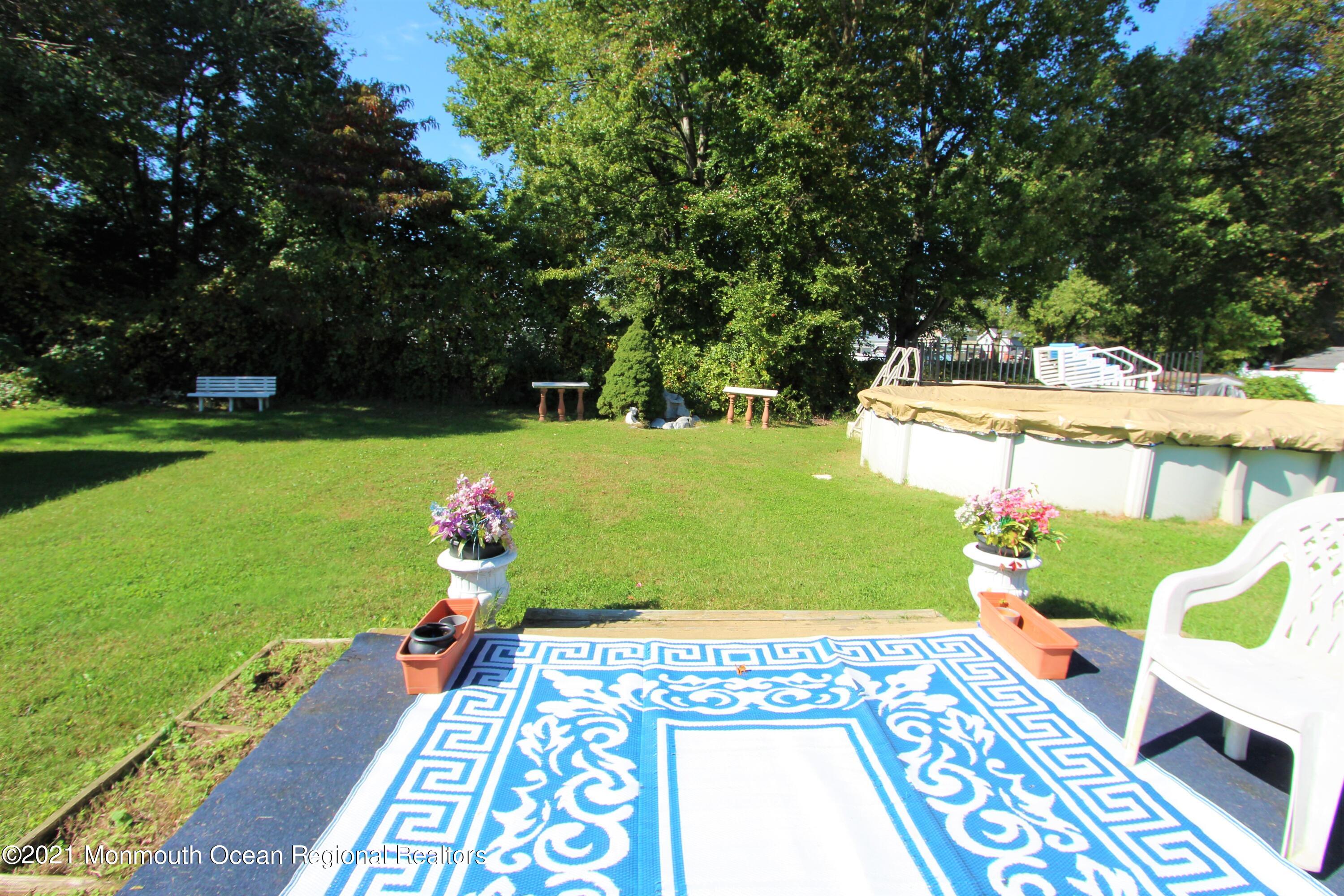 18 Rothbard Road Hazlet, NJ 07730 - Photo 4 of 23 a backyard of a house with table and chairs