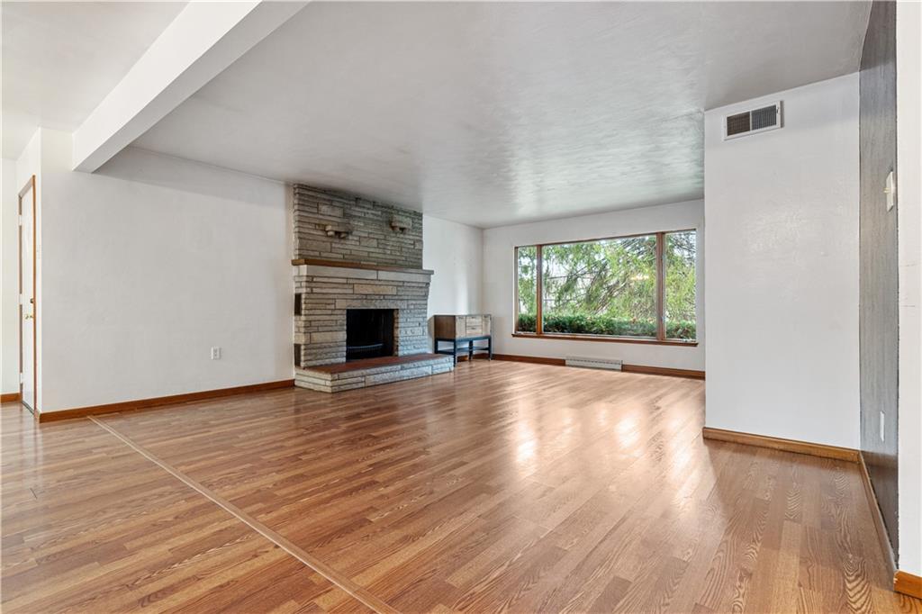 2321 Lovi Road Freedom, PA 15042 - Photo 6 of 35 a view of empty room with wooden floor and fireplace