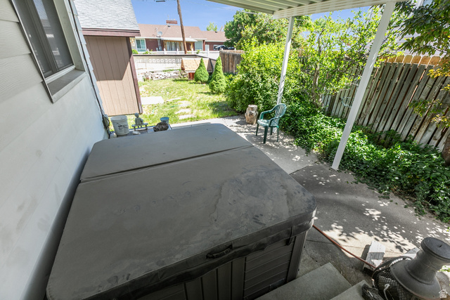 59 East Pinehurst Street Tooele, UT 84074 - Photo 20 of 22 Exterior patio space featuring a hot tub, concrete paving, and a covered pergola