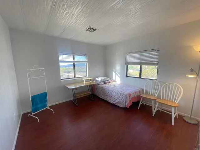 a bed room with a bed and a chair