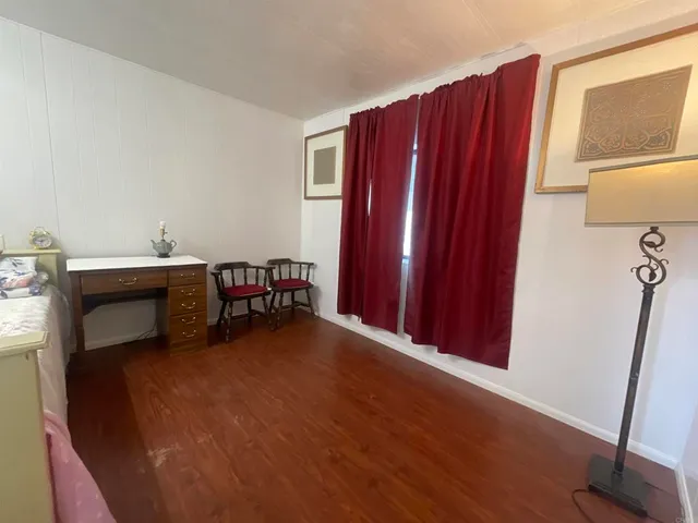 a view of a room with wooden floor