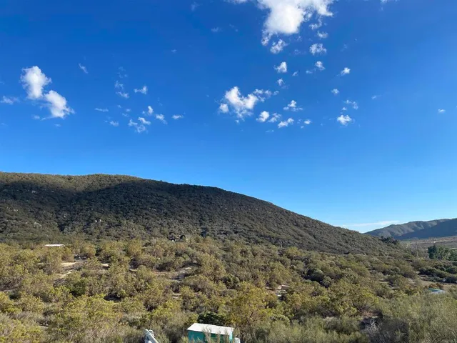 a view of a houses with a mountain in the background