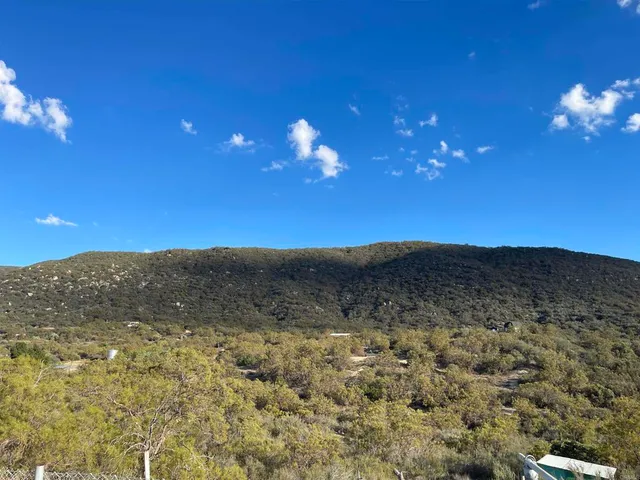 a view of a yard in front of mountains