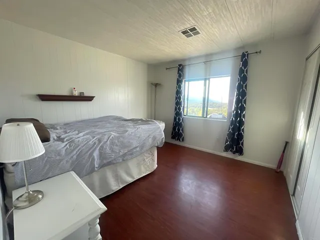 a bedroom with a bed and a window