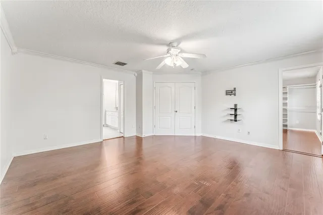 an empty room with fan and a ceiling fan