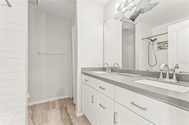 a bathroom with a double vanity sink and a mirror