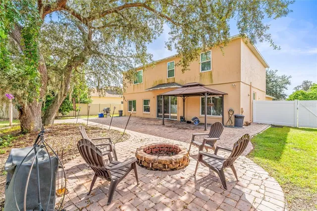 a view of a house with swimming pool and sitting area