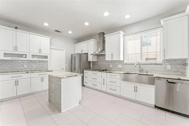 a kitchen with granite countertop white cabinets white appliances with a sink and dishwasher