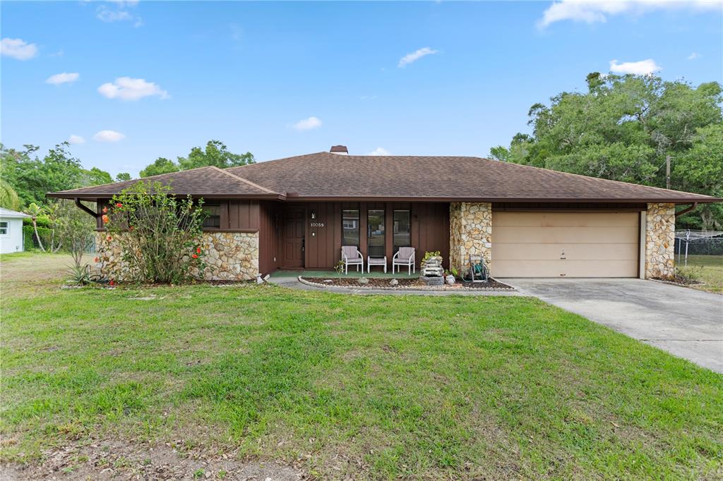 10059 Sali Drive Orlando, FL 32817 - Photo 1 of 1 a front view of a house with garden