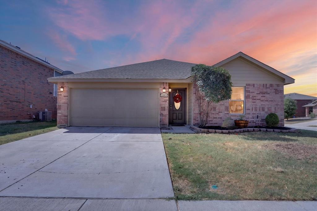 Brick and siding exterior with an attached garage