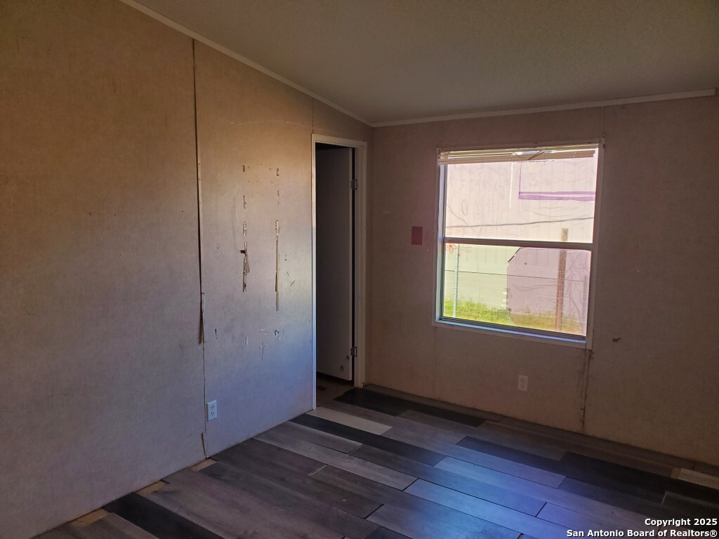754 Kayroe Road Adkins, TX 78101 - Photo 8 of 10 an empty room with wooden floor and windows