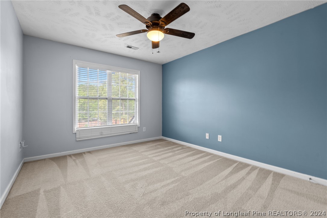 39 Fair Barn Road Sanford, NC 27332 - Photo 21 of 48 an empty room with a window and a fan