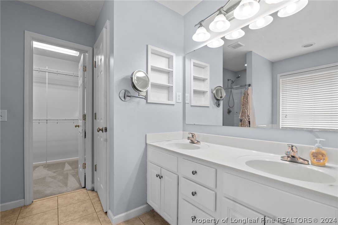 39 Fair Barn Road Sanford, NC 27332 - Photo 28 of 48 a bathroom with a sink a light fixture and a mirror