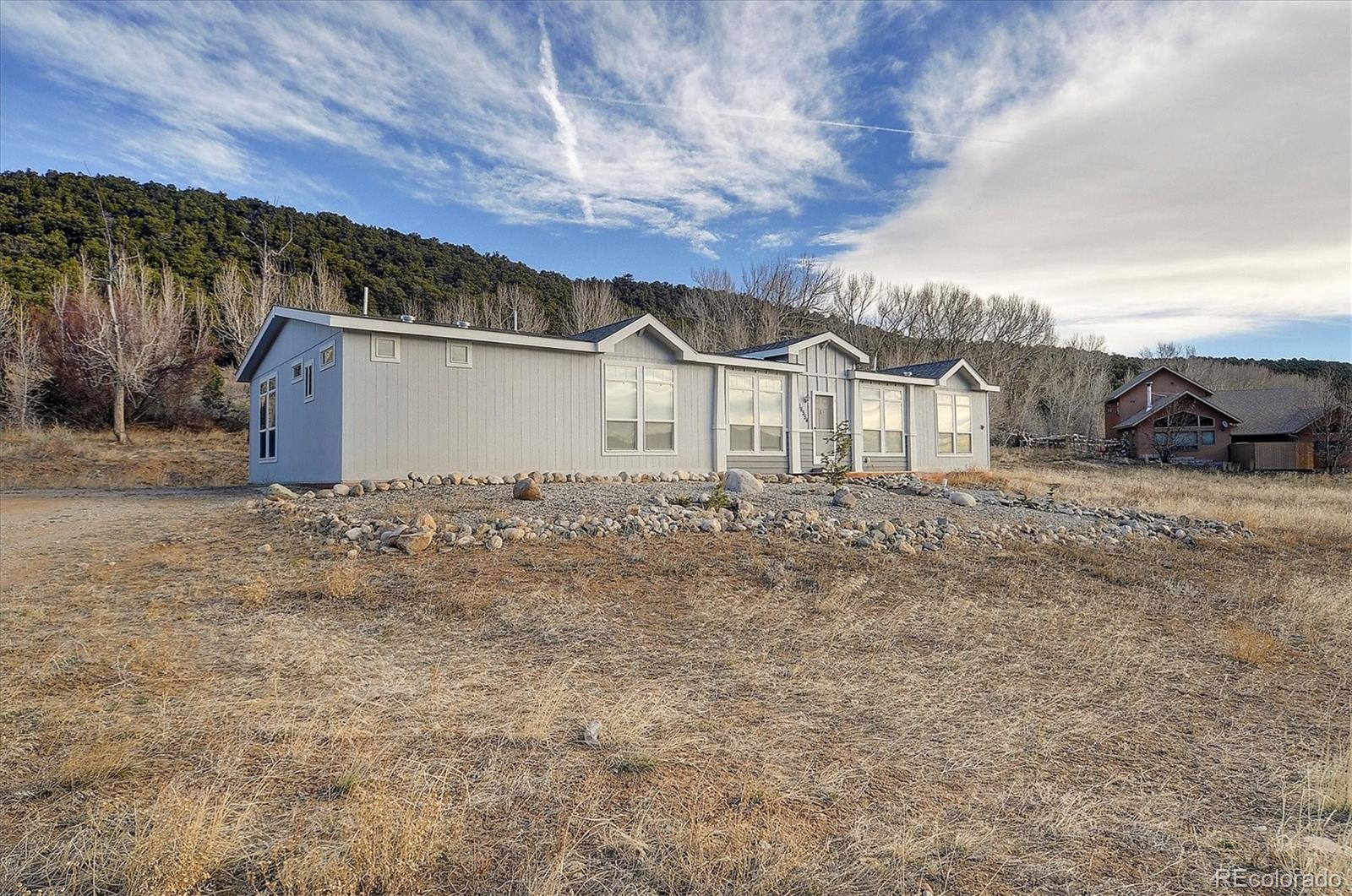 16554 Rocky Mountain Road Salida, CO 81201 - Photo 3 of 33 front view of a house with a dry yard