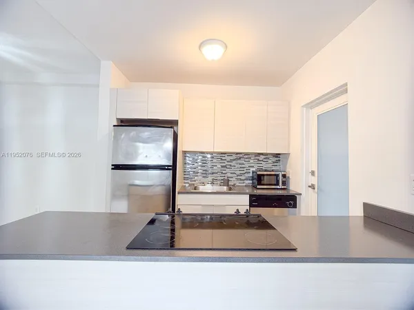 a kitchen with a sink cabinets and appliances