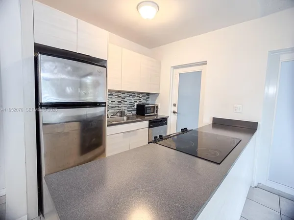 a view of an empty room and a window