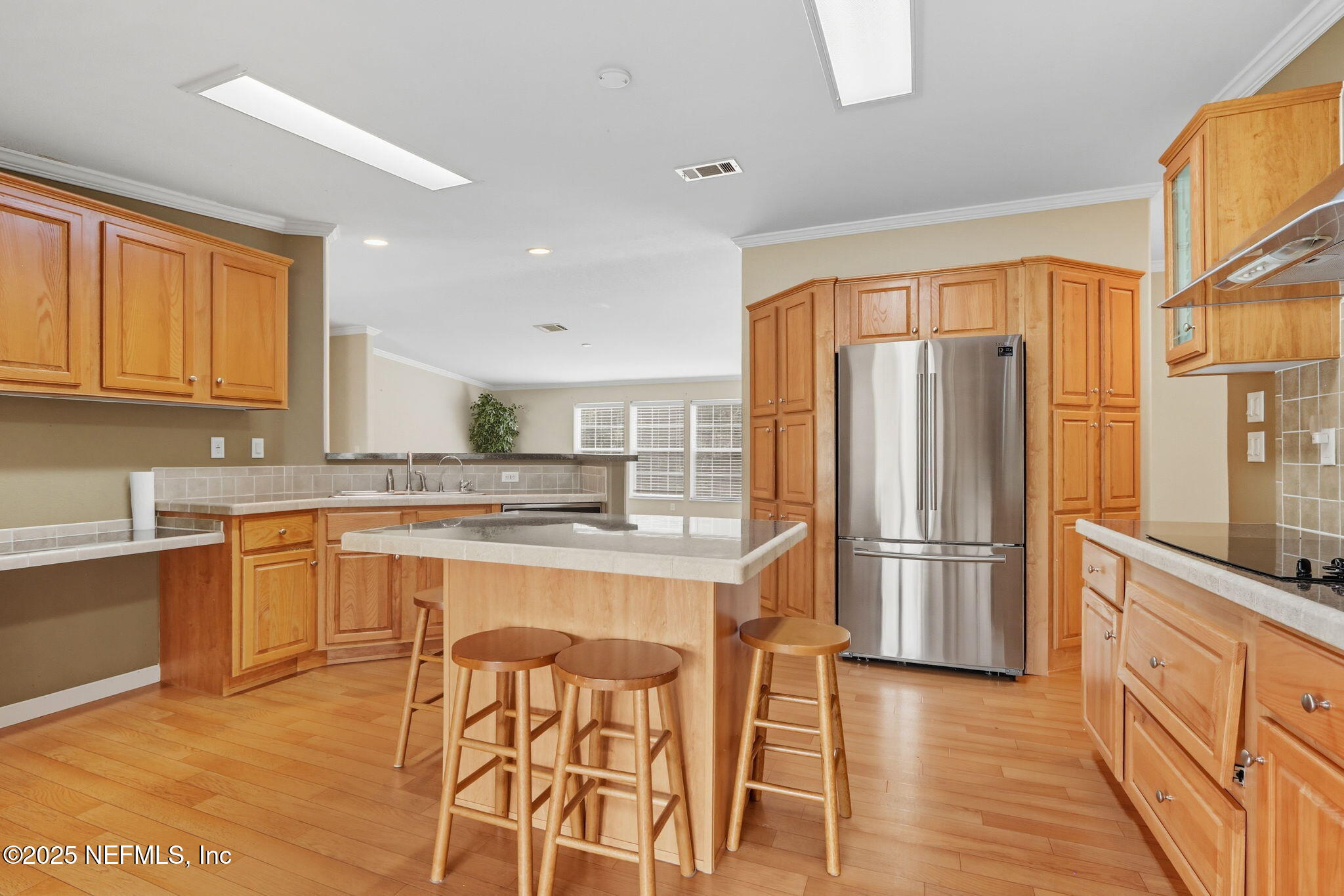 2054 Louie Carter Road Jacksonville, FL 32234 - Photo 20 of 32 a kitchen with stainless steel appliances granite countertop a refrigerator a sink dishwasher a stove with wooden cabinets and floor