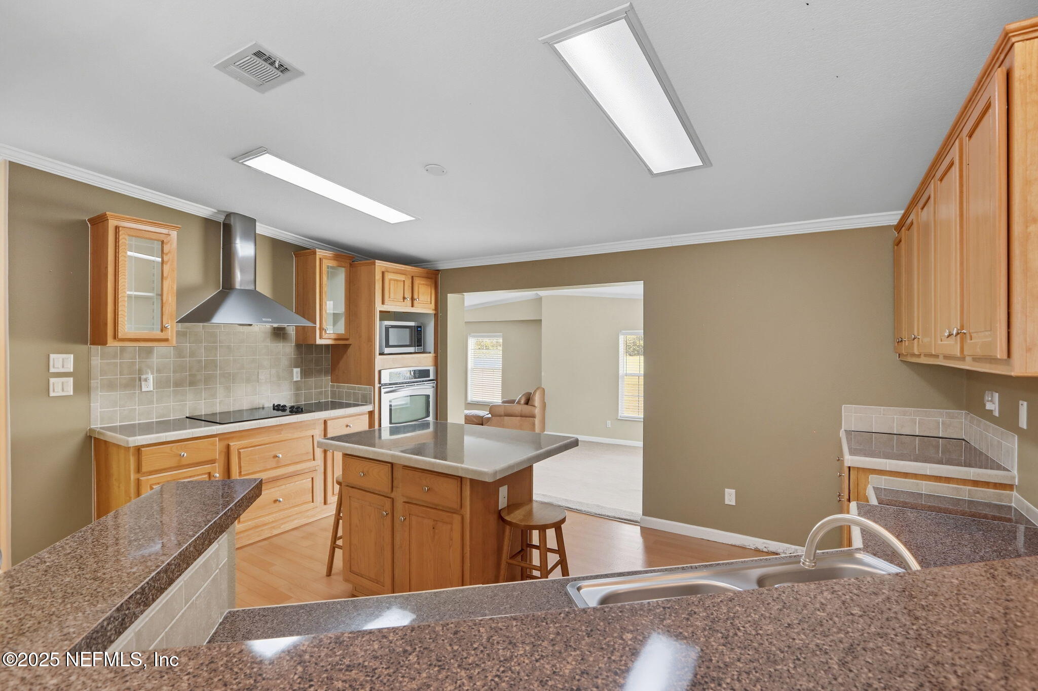 2054 Louie Carter Road Jacksonville, FL 32234 - Photo 21 of 32 a kitchen with a sink stove and cabinets