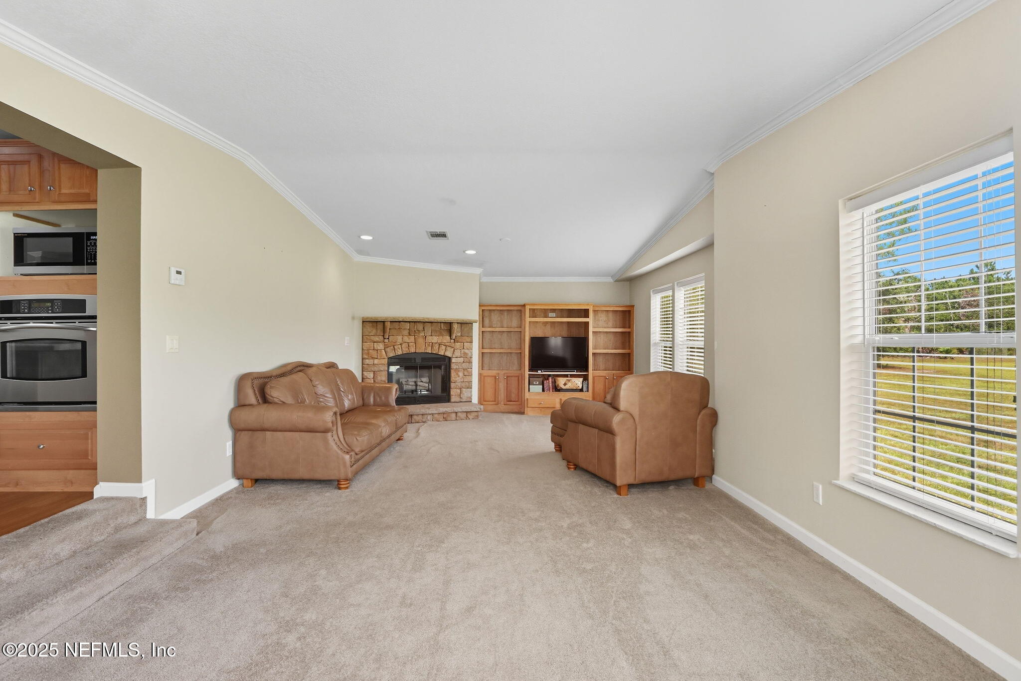 2054 Louie Carter Road Jacksonville, FL 32234 - Photo 22 of 32 a living room with furniture and a large window