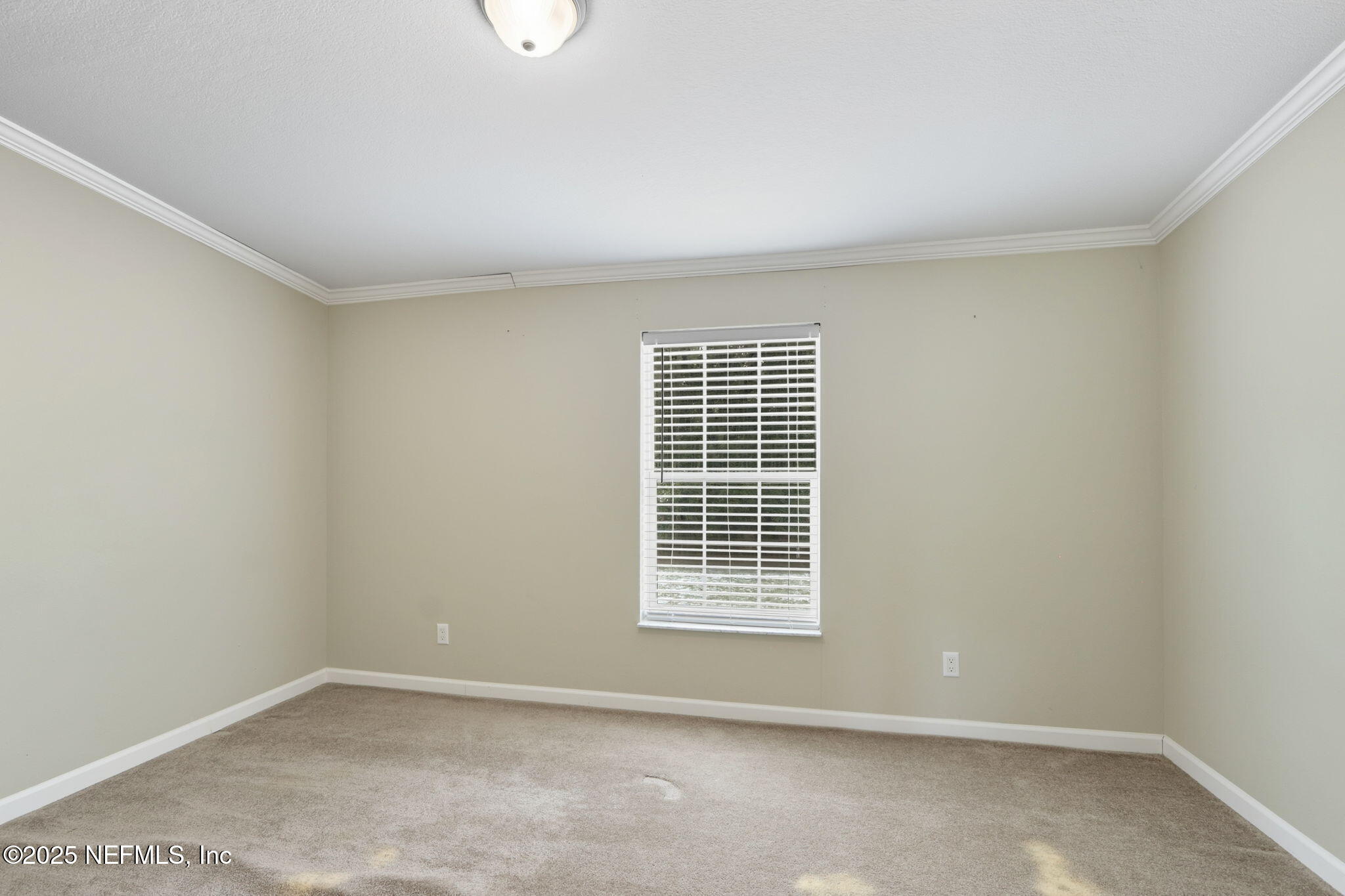 2054 Louie Carter Road Jacksonville, FL 32234 - Photo 9 of 32 an empty room with windows