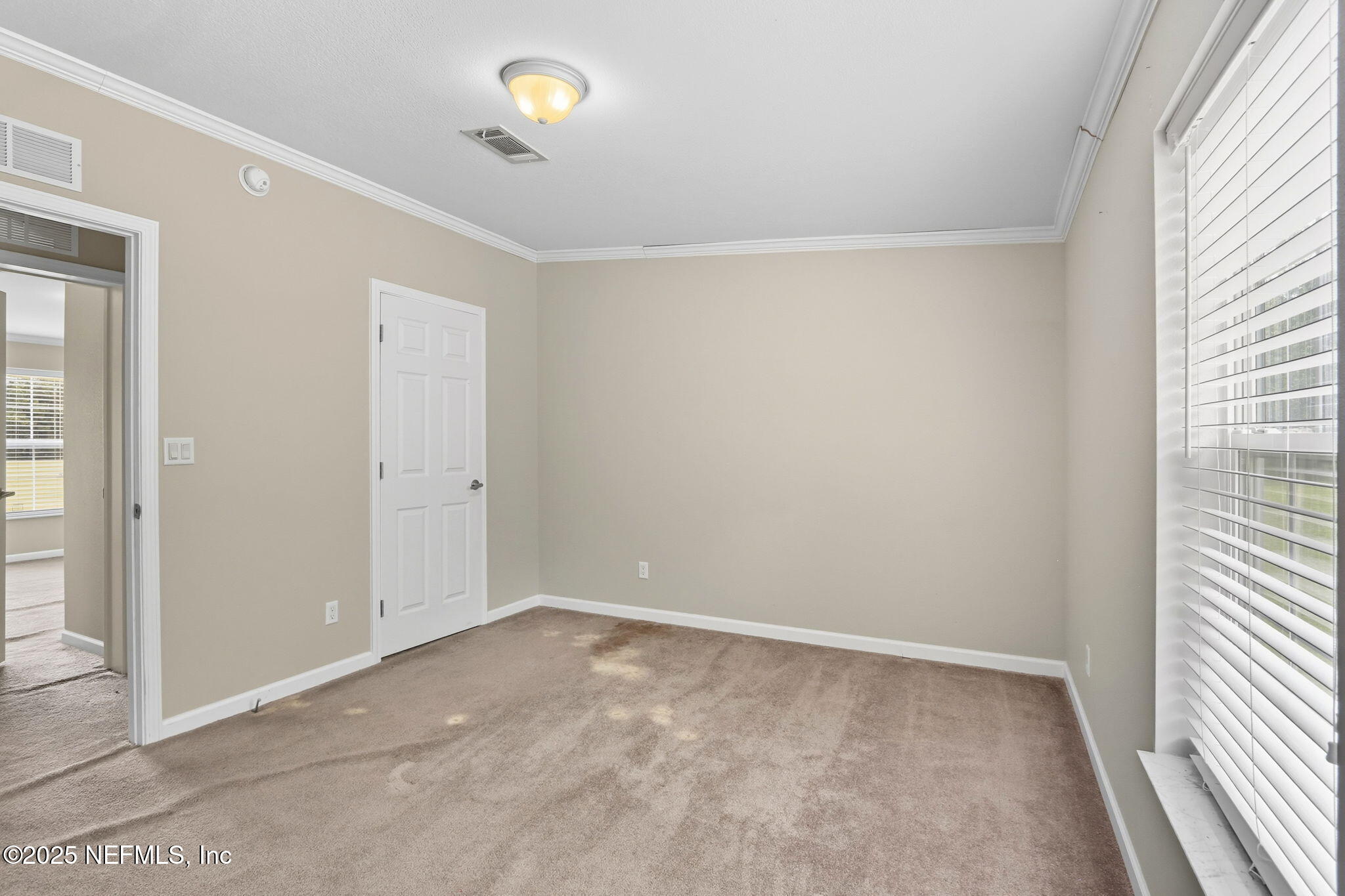 2054 Louie Carter Road Jacksonville, FL 32234 - Photo 10 of 32 a view of an empty room with a window