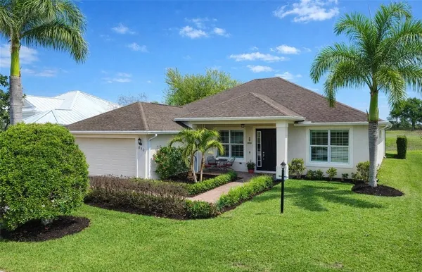 a view of a house with a yard and plants