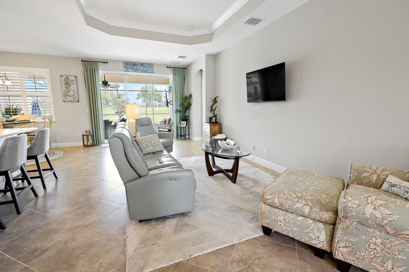 570 Gossamer Wing Way Sebastian, FL 32958 - Photo 12 of 36 a living room with furniture and a flat screen tv
