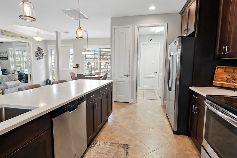 570 Gossamer Wing Way Sebastian, FL 32958 - Photo 18 of 36 a kitchen with a sink counter top space and stainless steel appliances