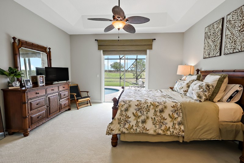 570 Gossamer Wing Way Sebastian, FL 32958 - Photo 21 of 36 a bedroom with a bed and a chandelier