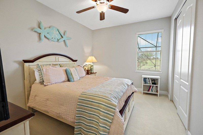 570 Gossamer Wing Way Sebastian, FL 32958 - Photo 26 of 36 a bedroom with a bed and a chandelier