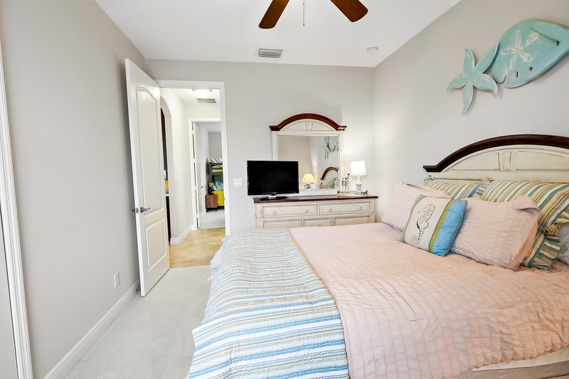 570 Gossamer Wing Way Sebastian, FL 32958 - Photo 27 of 36 a bedroom with a bed and a flat screen tv