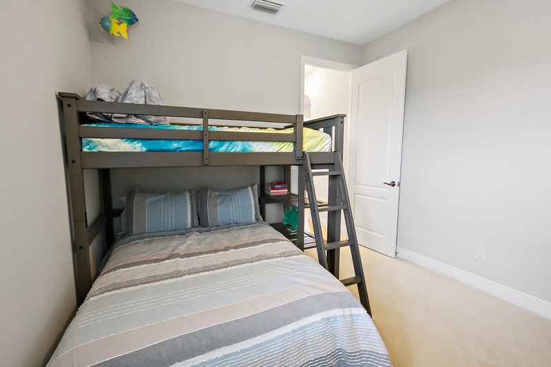 570 Gossamer Wing Way Sebastian, FL 32958 - Photo 29 of 36 a bedroom with a bed and a chandelier