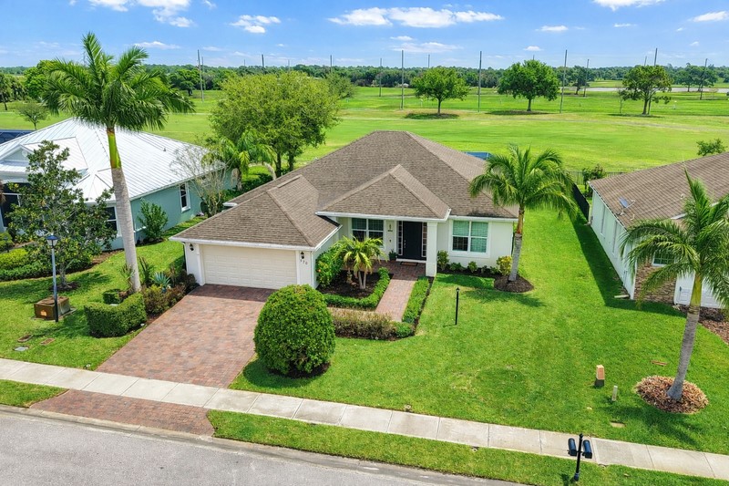 570 Gossamer Wing Way Sebastian, FL 32958 - Photo 3 of 36 a view of a backyard with table and chairs plants and a yard