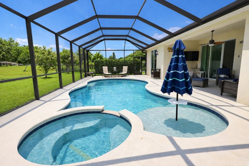 570 Gossamer Wing Way Sebastian, FL 32958 - Photo 33 of 36 a view of a swimming pool with a patio and a garden