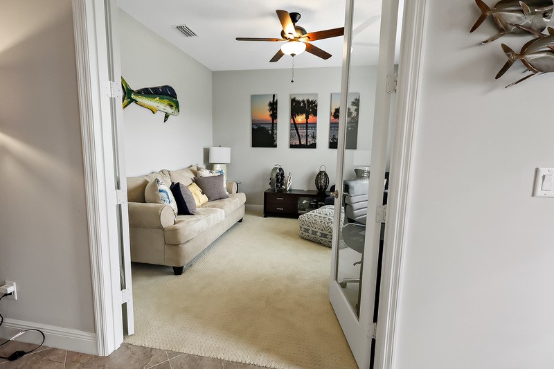 570 Gossamer Wing Way Sebastian, FL 32958 - Photo 7 of 36 a living room with furniture and a chandelier