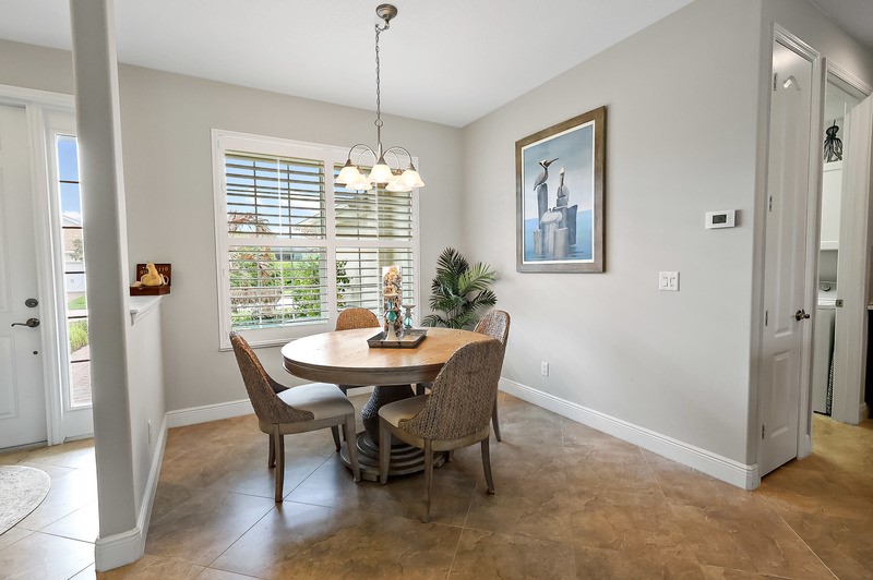 570 Gossamer Wing Way Sebastian, FL 32958 - Photo 10 of 36 a dining room with furniture a chandelier and window