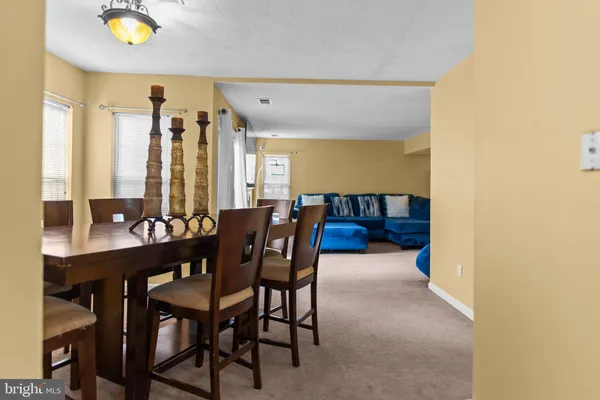 a view of a dining room with furniture and window